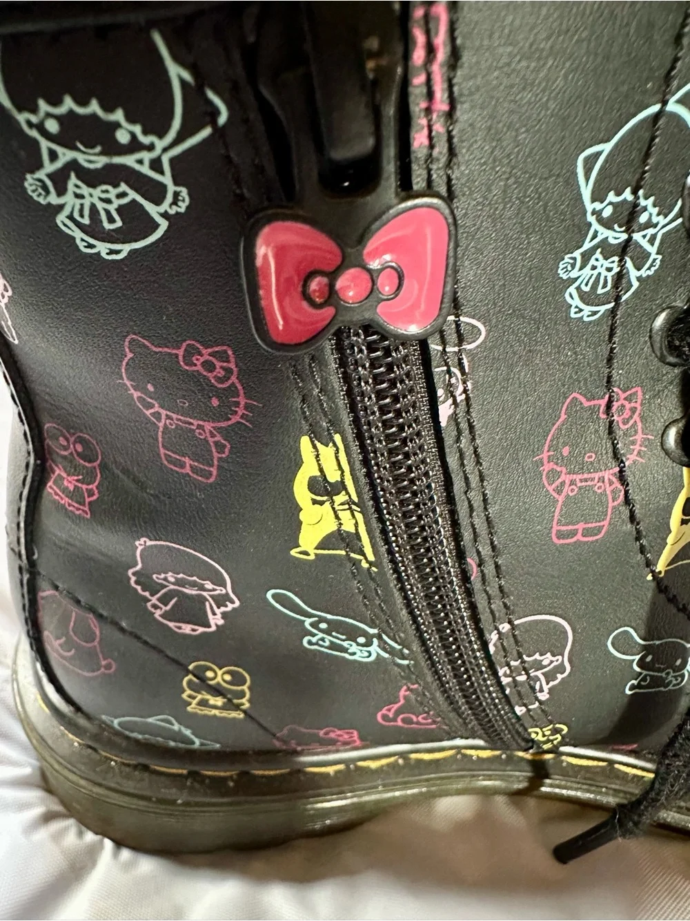 Dr. Martens Kids Black Boots with Multicolor Sanrio Print and Pink Bow Charm